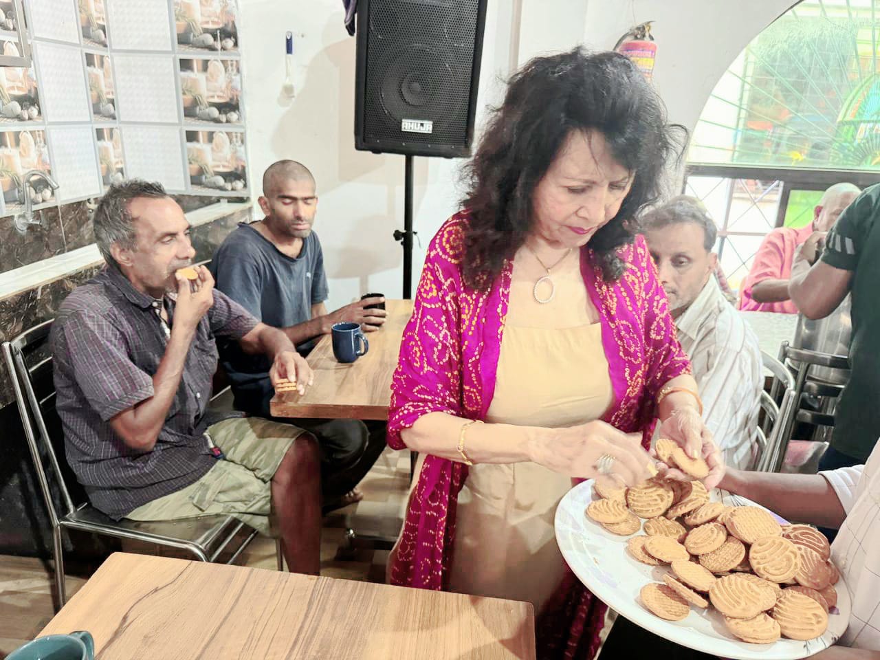 Kadambari serving refreshments to residents