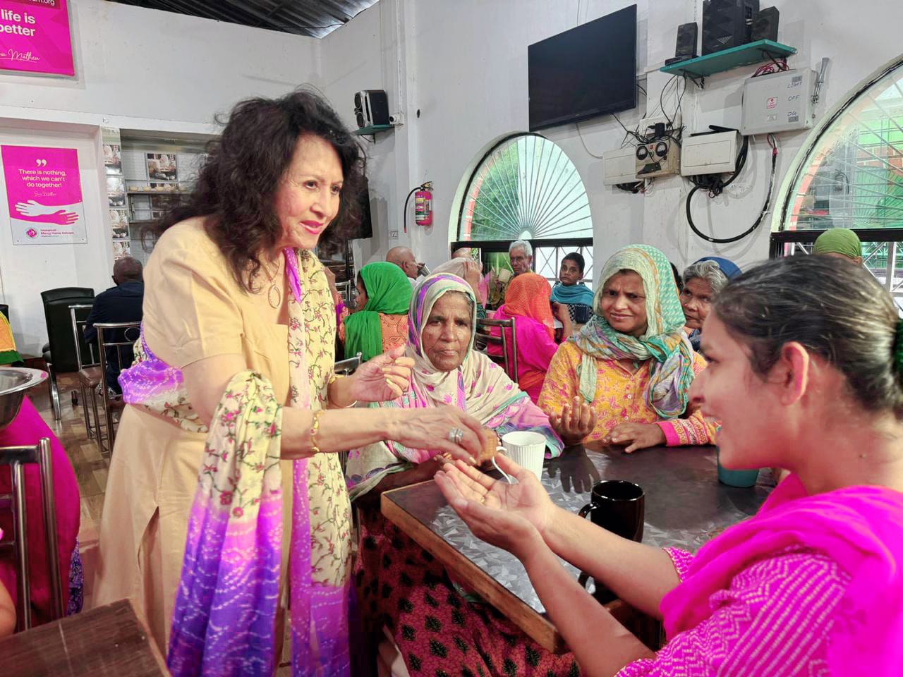 Kadambari speaking with elderly residents at a care home