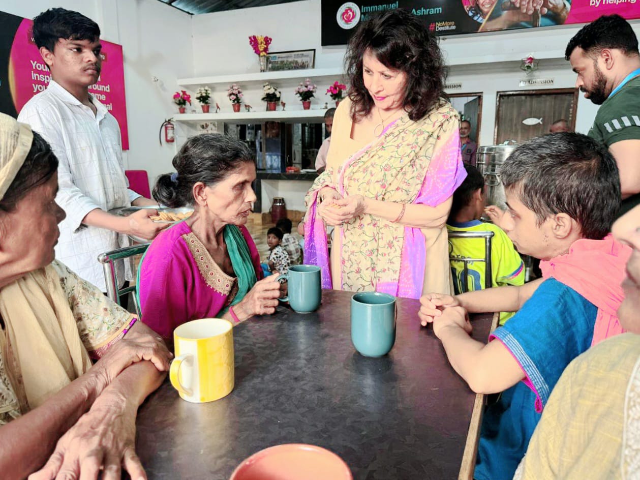 Kadambari sharing tea and conversation at an outreach event